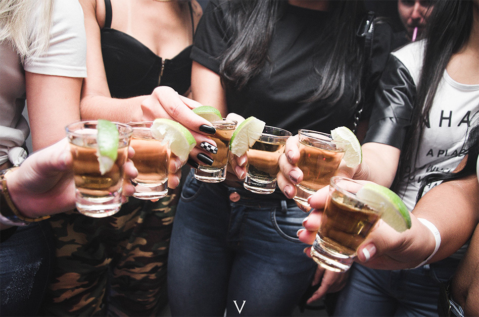 6 girls hold shots of tequila