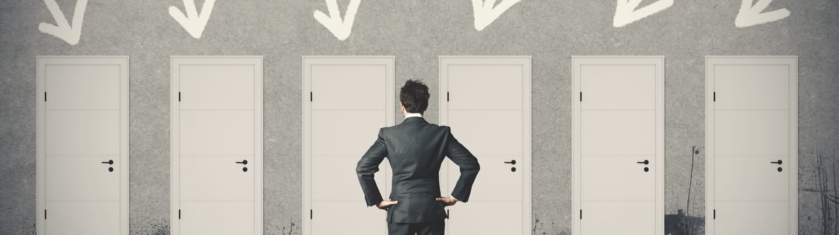 Man standing in front of 6 white doors