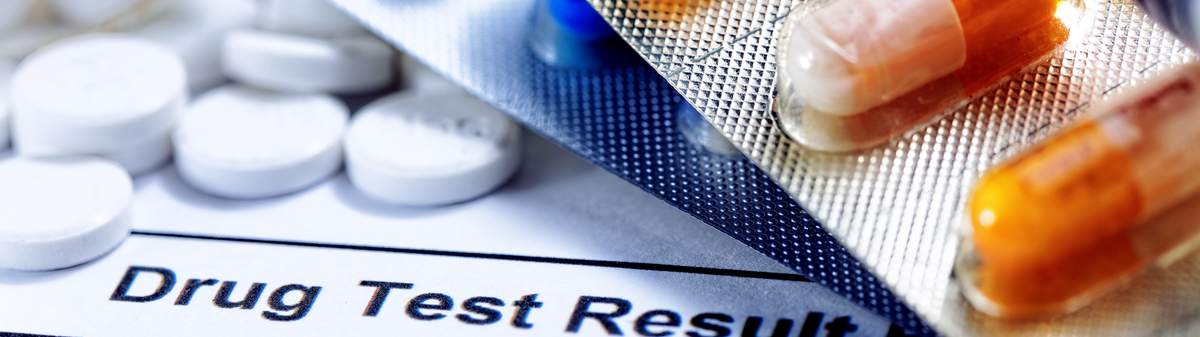 Pills sitting on top of a drug test form