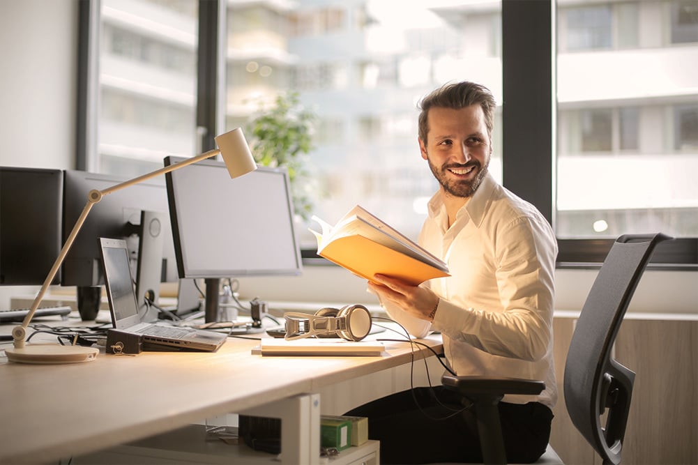 smiling employee working at his desk