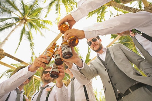 men toasting with beer bottles