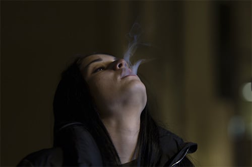 woman with smoke coming out of her mouth
